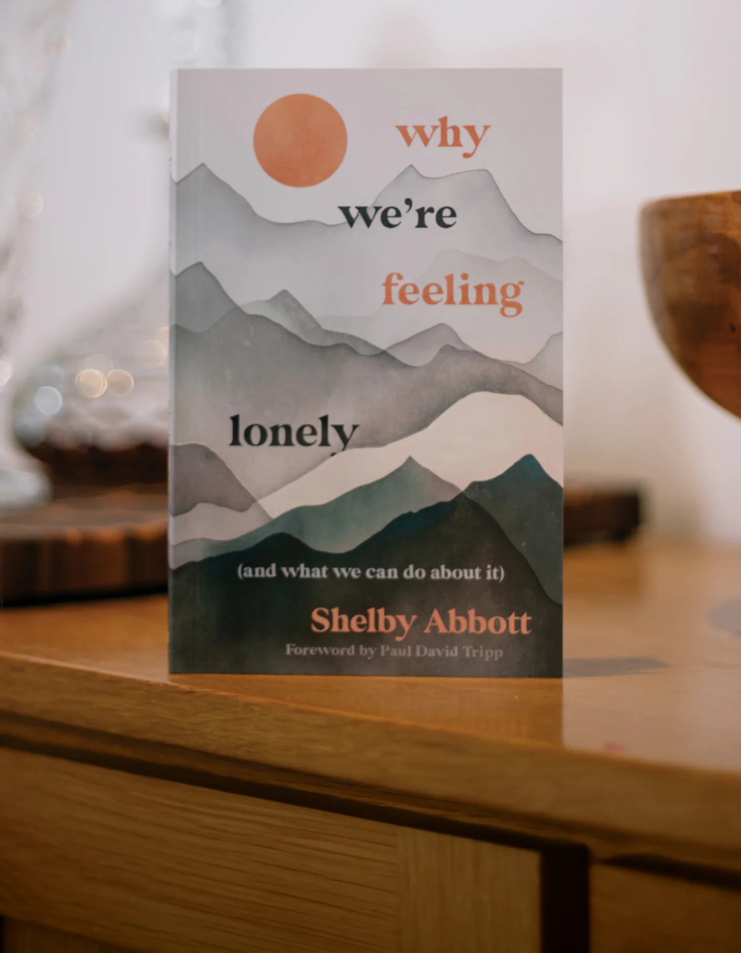 Photograph of Why We're Feeling Lonely on a table on a wooden floor