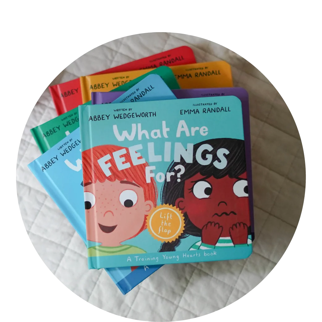 Photograph of What Are Feelings For? on top of a stack of other books in the Training Young Hearts series