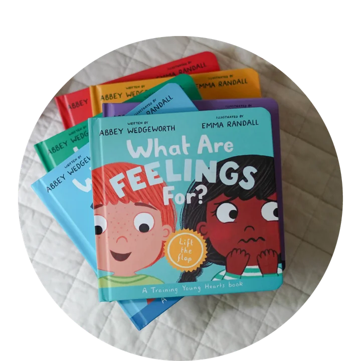 Photograph of What Are Feelings For? on top of a stack of other books in the Training Young Hearts series