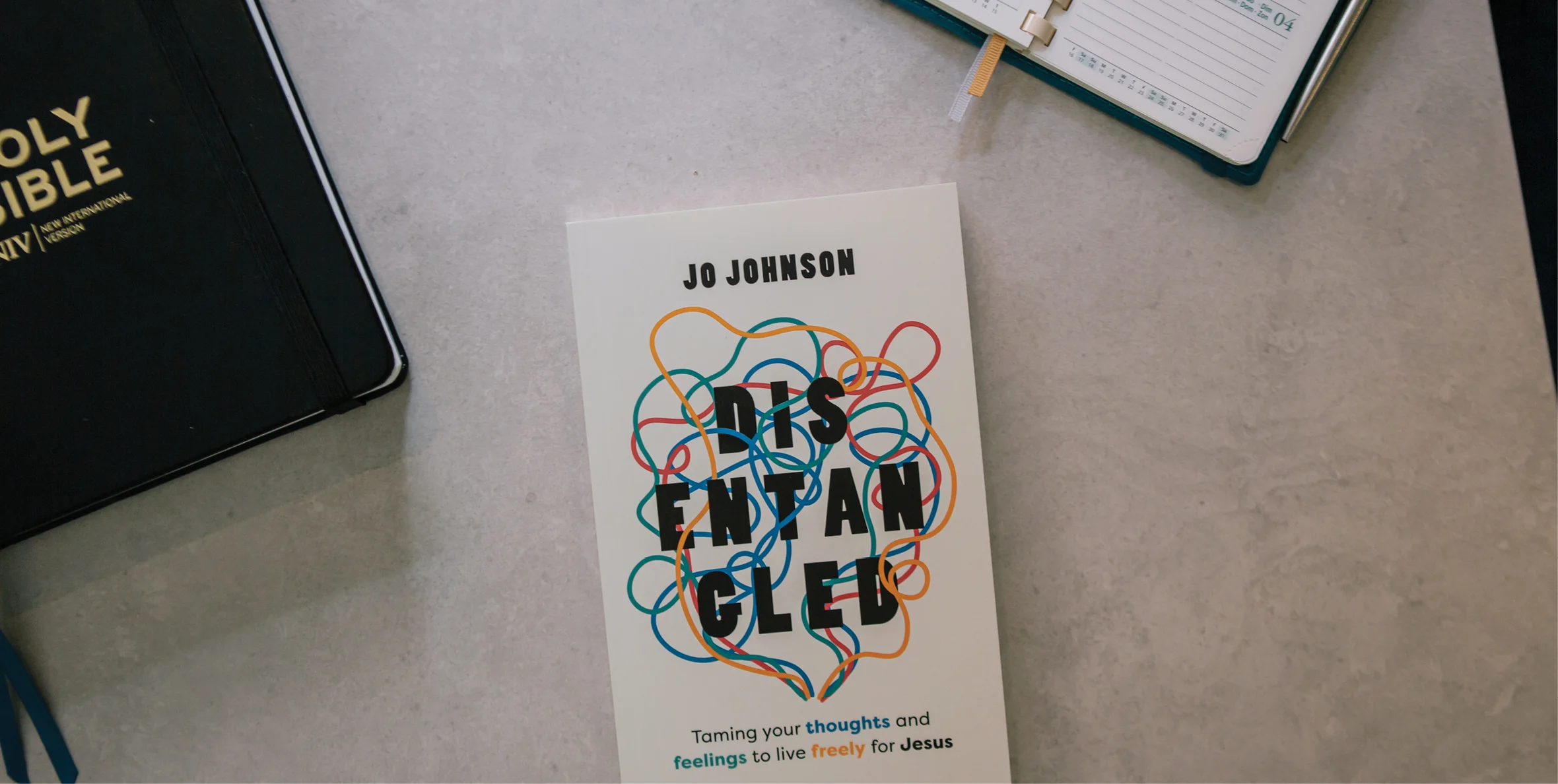 Photograph of Disentangled by Jo Johnson on a table near a Bible