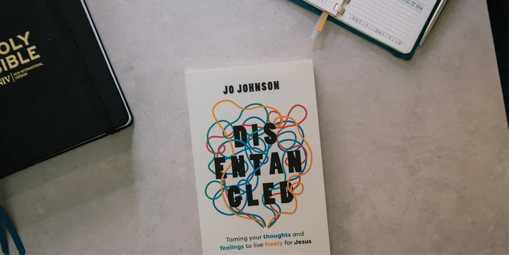 Photograph of Disentangled by Jo Johnson on a table near a Bible