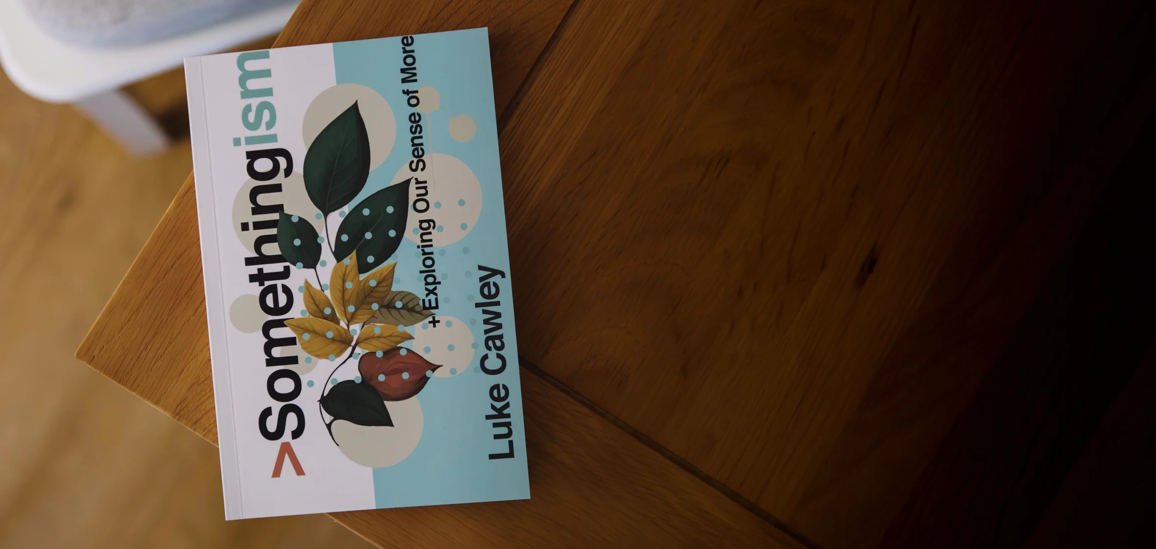 Photograph of Somethingism by Luke Cawley on a wooden table