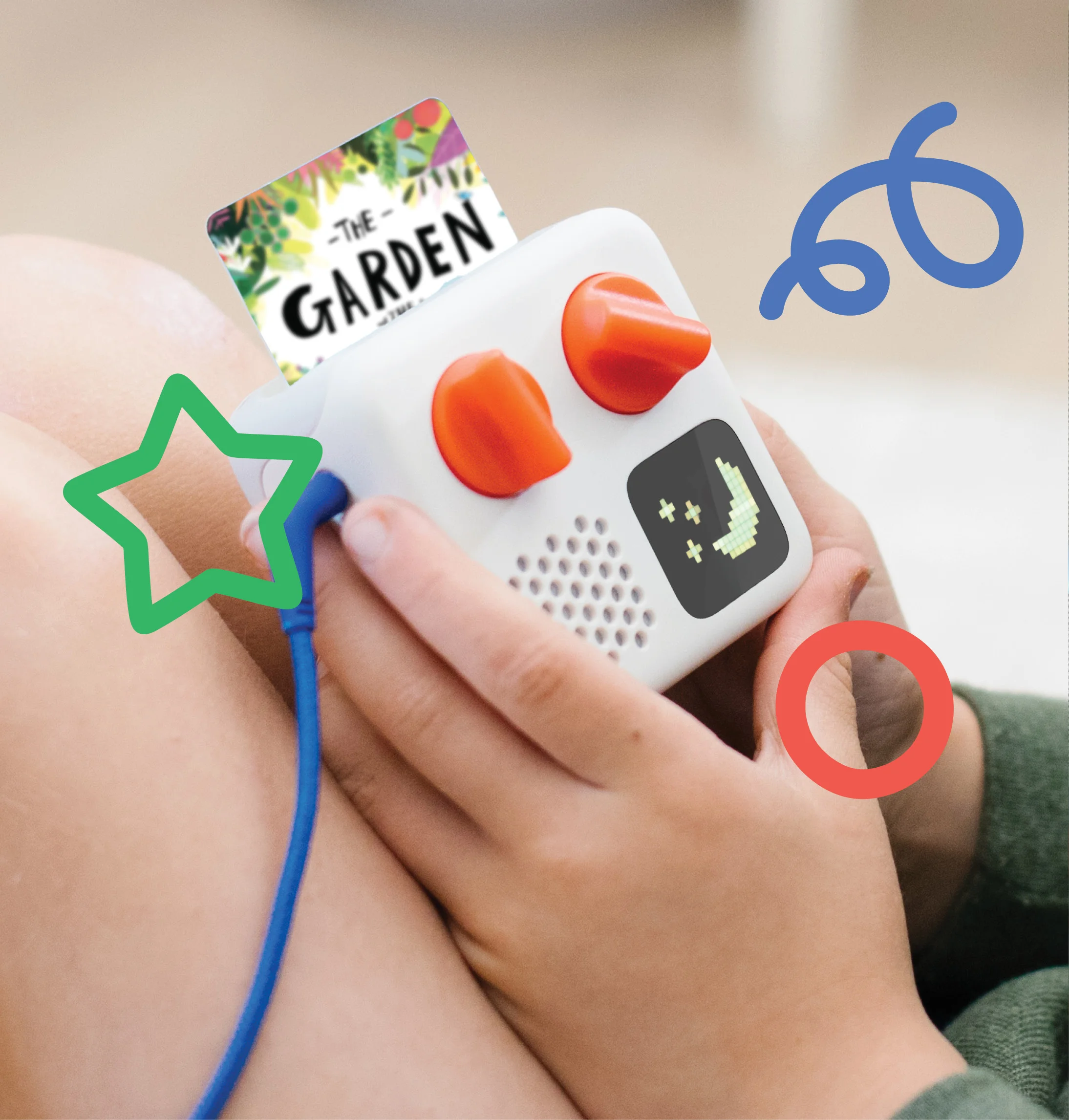 Child holding a yoto player with The Garden, the Curtain, and the Cross & Other Stories in the player