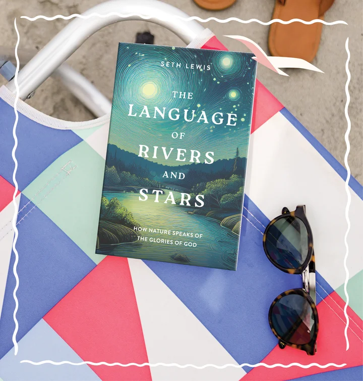 Photograph of The Language of Rivers and Stars on a beach chair near some sunglasses