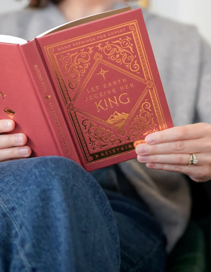 Photograph of someone holding Let Earth Receive Her King